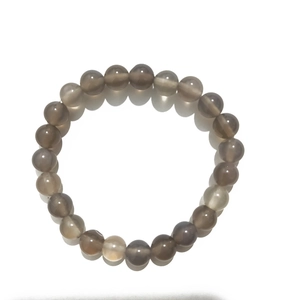 Macro detail of 8mm natural weathering agate beads on an elastic stone bracelet