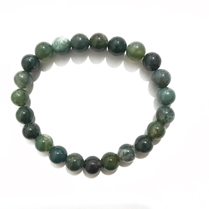 Detail of 8mm natural moss agate beaded bracelet showing green marble texture and round polish
