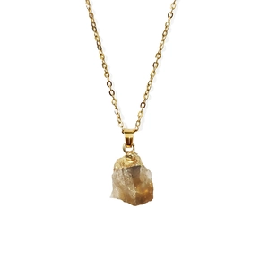Detail van vergulde rand op onregelmatige natuurstenen hanger met roestvrijstalen ketting