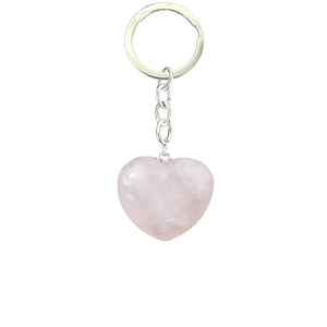 Natural heart-shaped rose quartz stone keychain with silver metal chain on white background