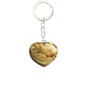 Natural landscape stone heart keychain with silver metal ring on white background