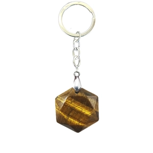 Macro detail of hexagon cut tiger eye stone pendant with silver metal keychain