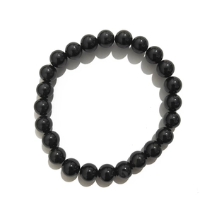Close-up of 8mm polished black agate beads with glossy finish on a beaded bracelet