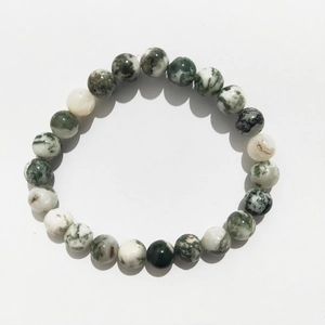 Detailed top view of 8mm green and white agate beaded bracelet on white background