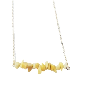 Minimalist necklace featuring irregular natural yellow stone pendant and gold chain
