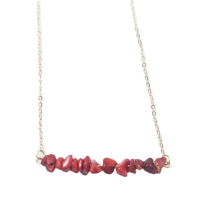 Minimalist gold necklace featuring irregular red natural stone crystals on a delicate chain