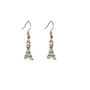 Gold star and light blue enamel Eiffel Tower drop earrings against white background