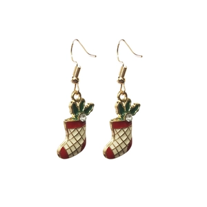 Detail view of festive red Christmas stocking drop earrings with holly leaf and rhinestone