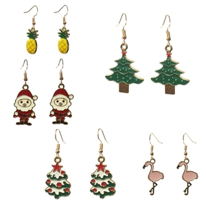 Macro detail of five pairs colorful enamel Christmas and tropical dangle earrings set