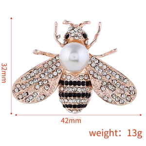 Cartoon bee brooch with white pearls and sparkling rhinestones on golden alloy