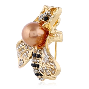 Golden honey bee brooch with champagne pearl and sparkling rhinestones on white background