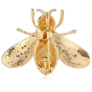 Back view of golden bee alloy brooch showing the safety pin fastener and detailed texture