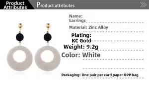 Detail of plush geometric hoop earrings with gold studs and white fuzzy rings