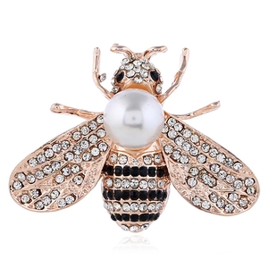 Detailed view of bee brooch with rose gold plating, clear crystals, and white pearl inlay
