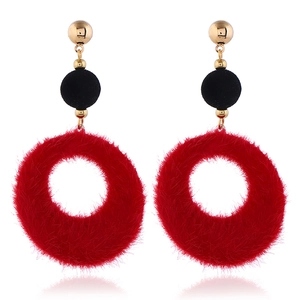 Detail showing oversized red faux fur hoop earrings with black flocked beads and gold studs