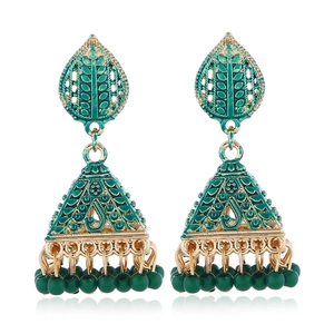 Macro view of green enamel Jhumka earrings with gold plating and hanging bead fringe