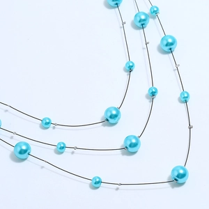 Three-layer multilayer pearl necklace with light blue beads on black wire chains