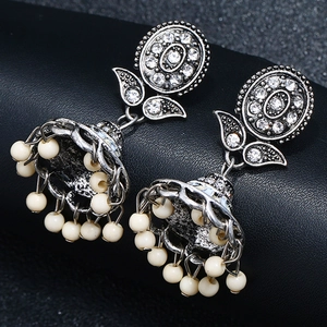 Close-up of bohemian tassel earrings with vintage silver finish and rhinestones