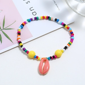 Detailed close-up of handmade colorful seed bead bracelet with a pink shell pendant charm