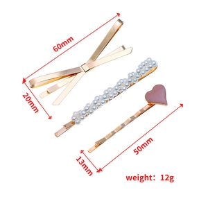 Set de 3 barrettes incluant un nœud doré, des perles et un clip à cœur rose
