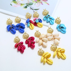 Detail of colorful fan-shaped tassel earrings with golden starfish and shell motifs