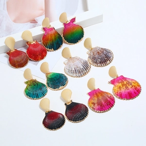 Macro shot of colorful shell earrings with gold fan studs in various gradient shades