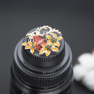 Detailed view of Christmas reindeer brooch with red rhinestones and yellow enamel flowers