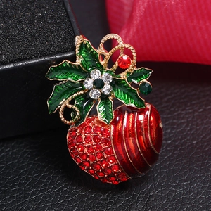 Detailed view of Christmas red apple brooch with green enamel leaves and crystals