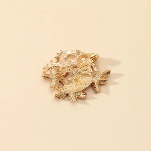 Back view of golden alloy Christmas reindeer brooch with secure pin buckle and matte texture