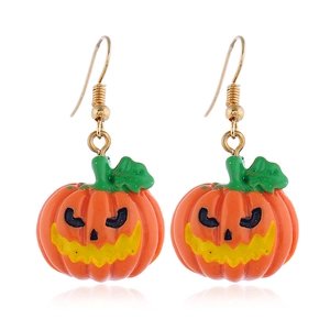 Gros plan détaillé des boucles d'oreilles citrouille d'Halloween en résine orange