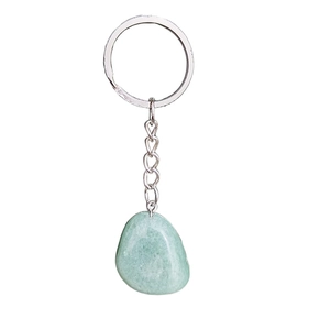 Détail macro d'un pendentif en pierre naturelle verte polie avec anneau de porte-clés argenté