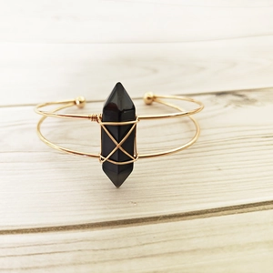 Handmade gold wire wrapped open bangle featuring a natural black hexagonal crystal point