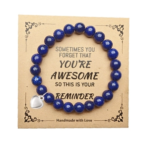 Lapis lazuli beaded bracelet with silver heart charm on an inspirational gift card