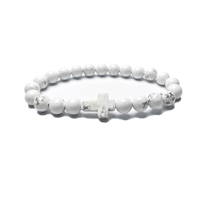 Polished white turquoise bead bracelet with a horizontal stone cross on white background