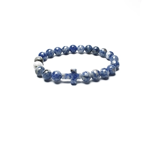 Close-up of blue and white natural stone beaded bracelet with a matching cross charm