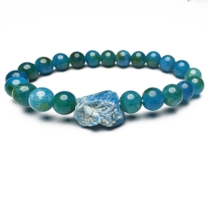 Primer plano de piedra azul natural irregular en una pulsera elástica con cuentas