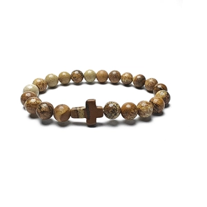 Detailed close-up of natural stone beaded bracelet featuring a cross pendant with earthy textures