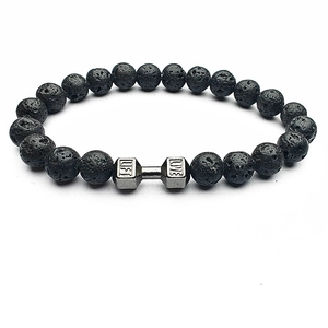Detail of porous black lava stone beads with a metal dumbbell charm engraved with LIVE LIFT