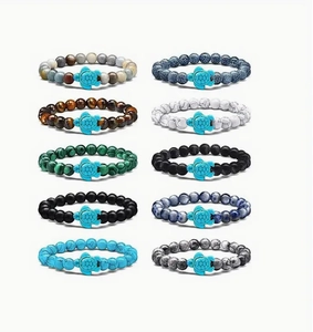 Close-up of ten beaded bracelets with diverse natural stones and turquoise turtle charms