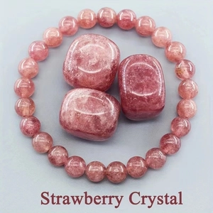 Macro detail of natural strawberry crystal beads and polished raw stones in pink hues