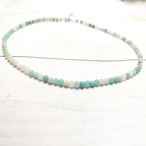 Detailed macro view of 4mm colorful tourmaline beaded necklace with silver lobster clasp