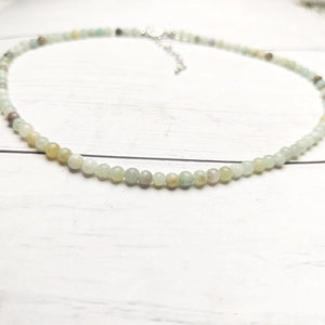 Close-up of 4mm multi-color gemstone beads with silver lobster clasp and extension chain