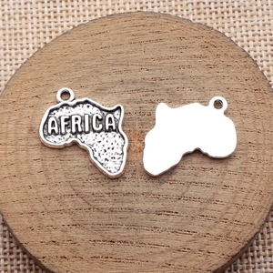 Antique silver Africa map charm with engraved AFRICA text on a wooden decorative block
