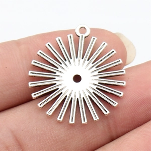 Vintage silver sunburst sun pendant with center cutout and top loop for jewelry making
