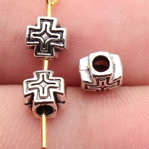 Silver cross spacer beads in antique style for DIY jewelry making on gold needles