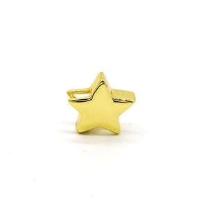 Close-up of a 3D gold star charm with a glossy mirror finish for DIY jewelry