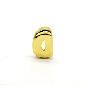 Detailed view of polished golden letter D puffy charm with a shiny mirror finish