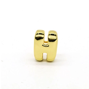 Close-up of golden polished letter H charm pendant for colorful cord bracelets