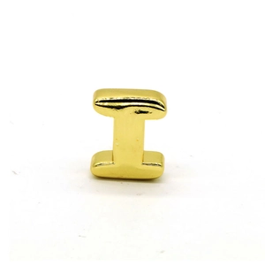 Close-up of a polished gold letter I bubble pendant charm with smooth metallic finish