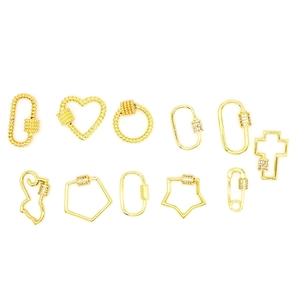 Detailed view of assorted gold screw clasp charms including heart and star shapes